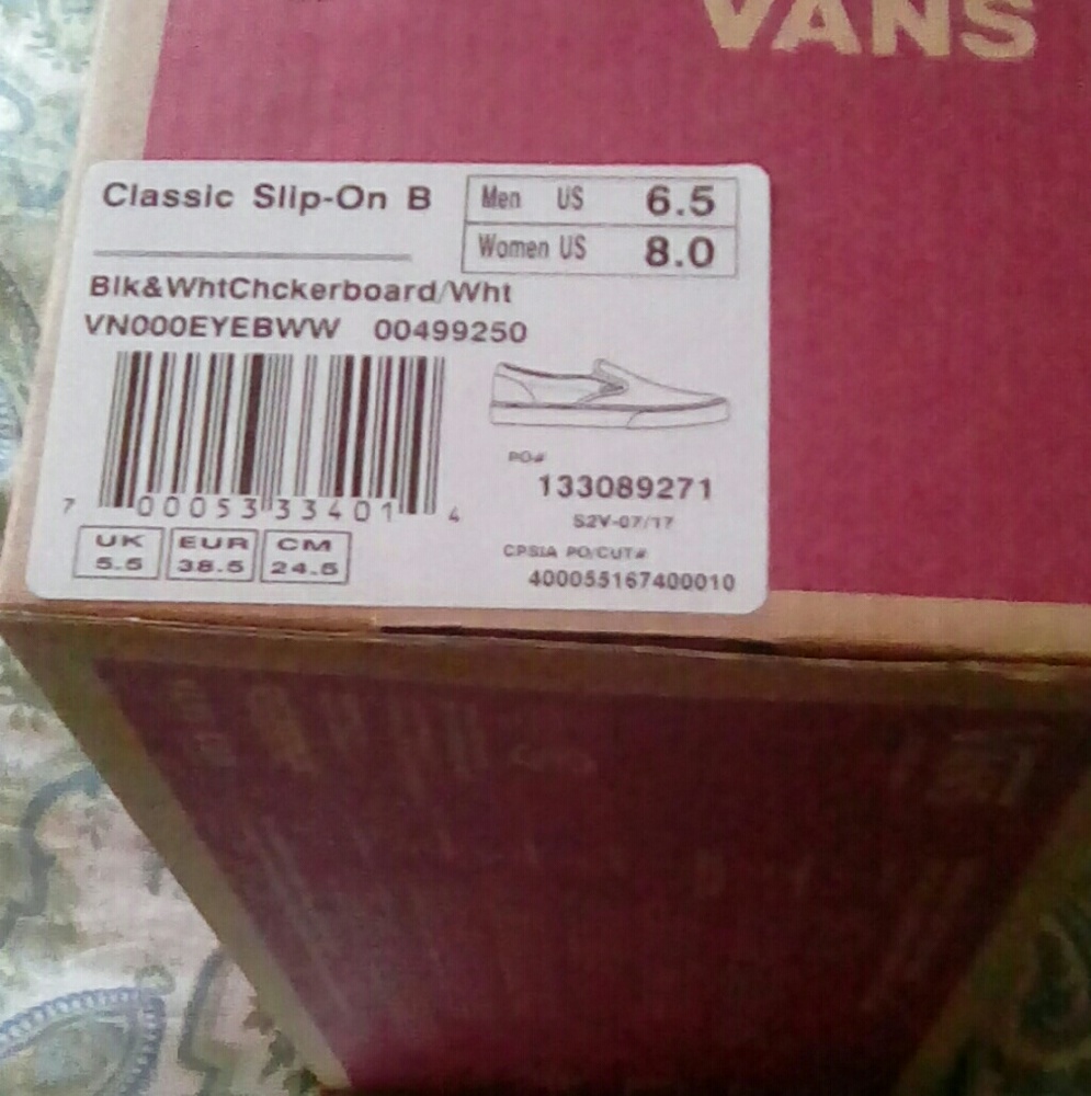 Black and off white checkered vans .