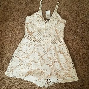 White embroidered romper with tan underlay