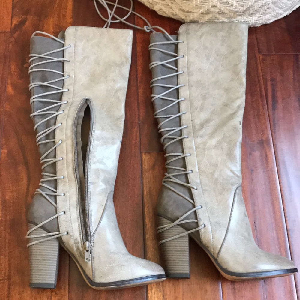 Knee high lace up boots.