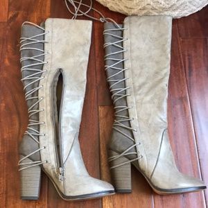 Knee high lace up boots.