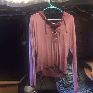 A long sleeved pinkish, reddish shirt hooded shirt