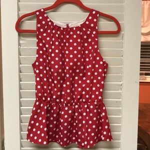 Sleeveless red blouse with white circles