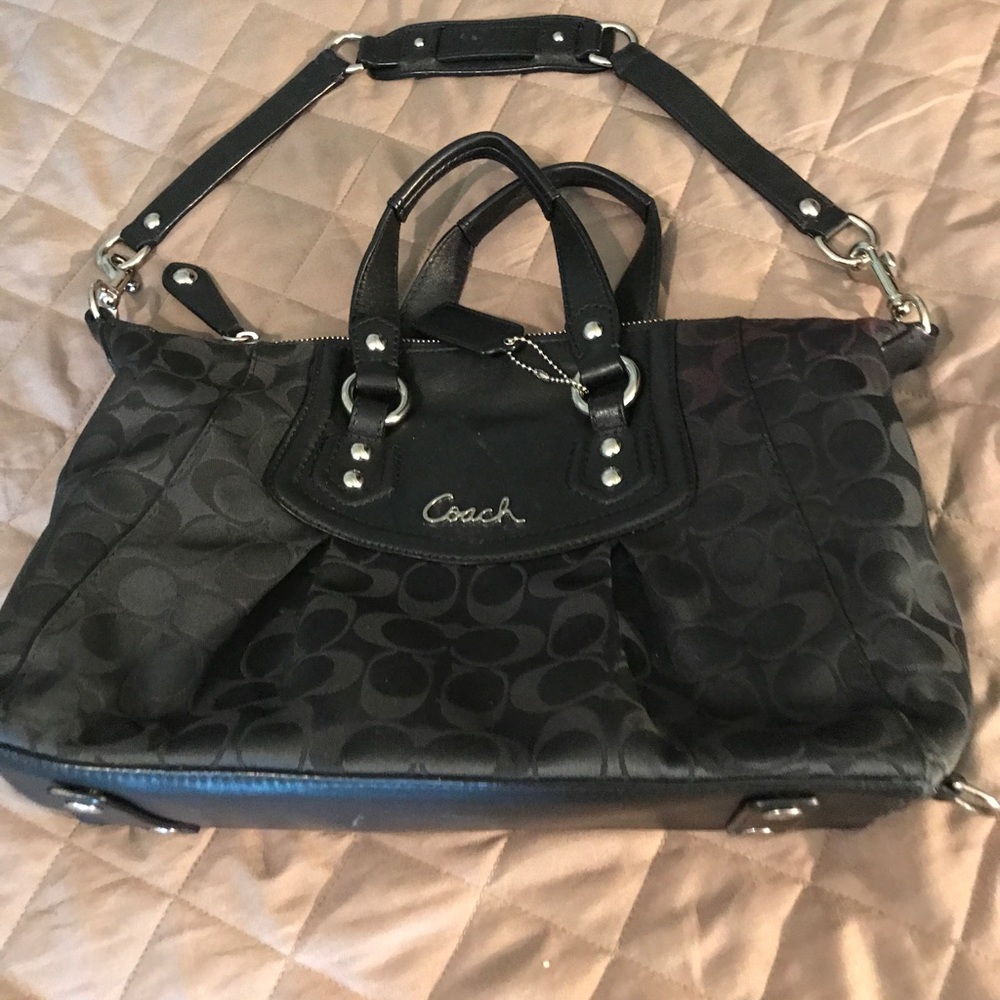 A black pre owned Coach handbag.