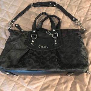 A black pre owned Coach handbag.