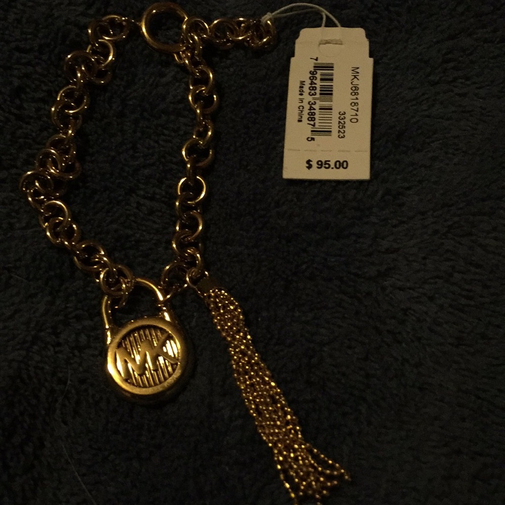 Michael Kors bracelet with a lock and a tassel