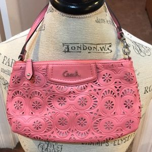 Coach wristlet. Pale pink with cutout design