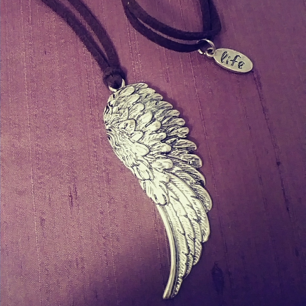 Brown leather wing feather necklace.