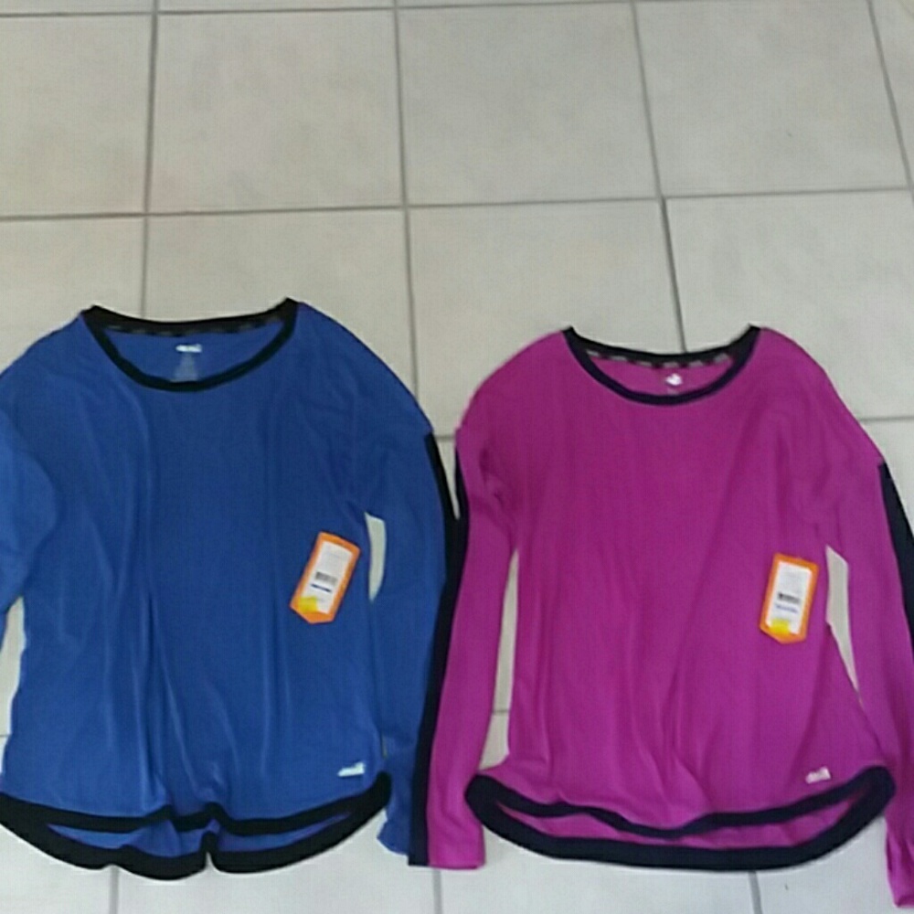Two long sleeve shirts still have tags on them