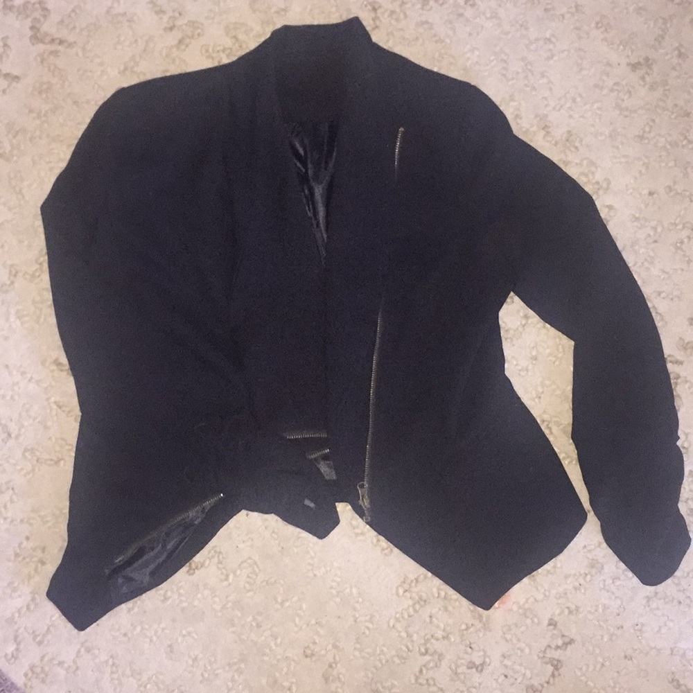 Black jacket with asymmetrical zipper.