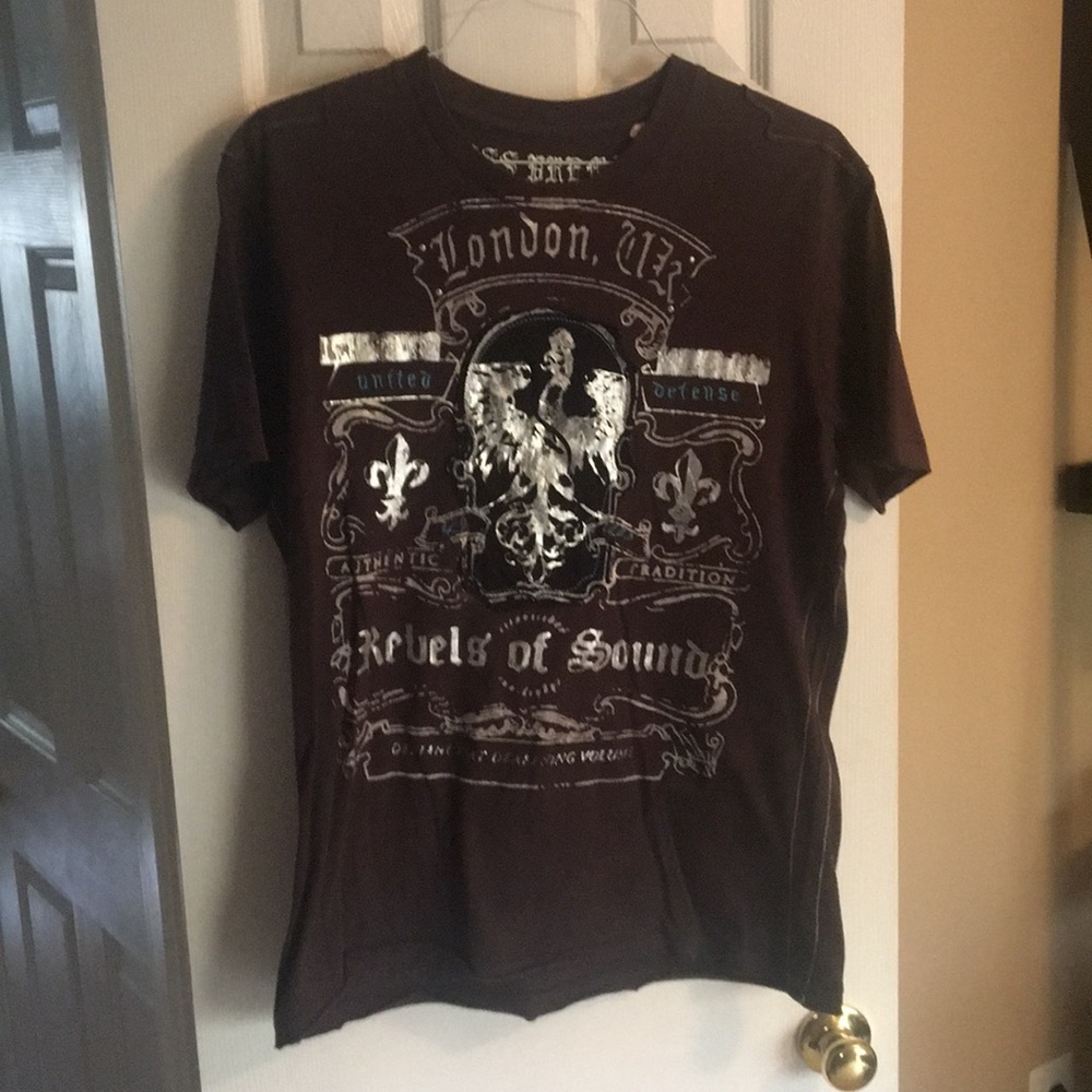 Guess tee shirt.  Studs at top of logo on front.