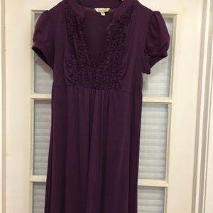 Purple t shirt dress with ruffles and tie back.