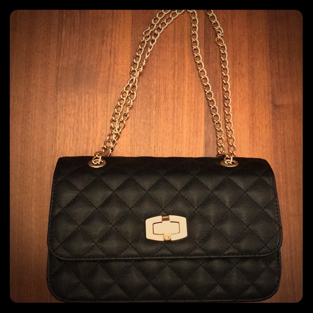 Black quilted flap purse with gold chain link