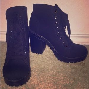 Boots, with a thick heel.