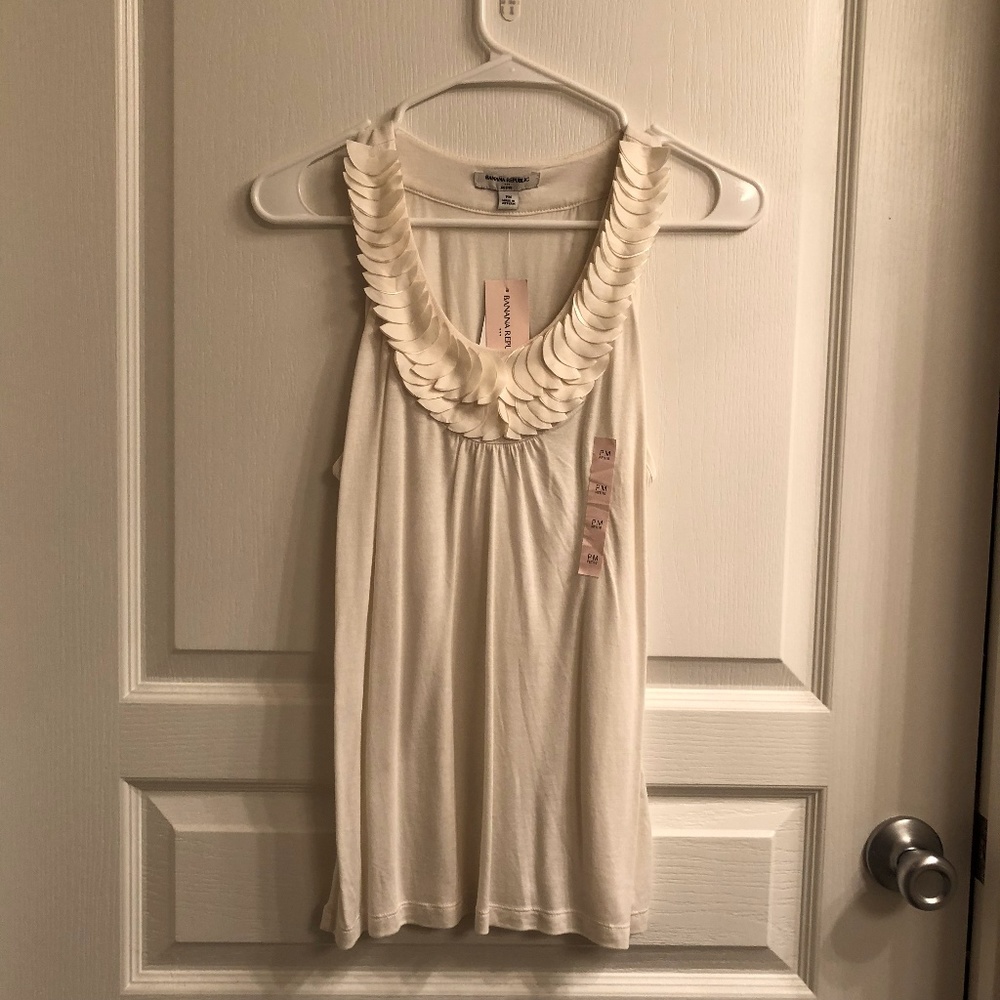 Flowy white top with layered applique detailing