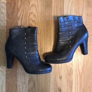 Brown booties with little brass accents.