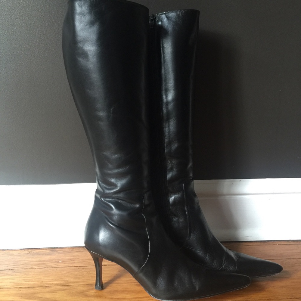 Tall black pointy-toe heeled boots