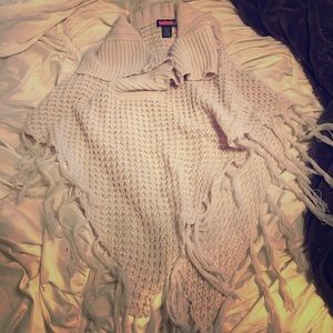 Cream colored poncho with button up neck