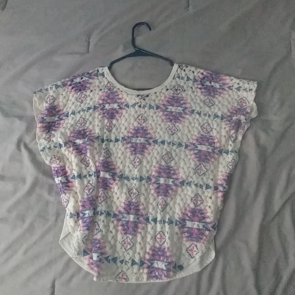 A shirt with colorful detailing on the front.