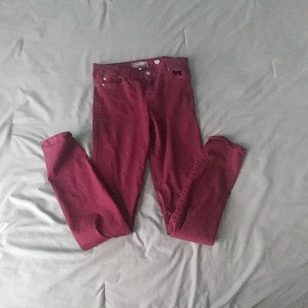 A pair of Maroon jeggings.