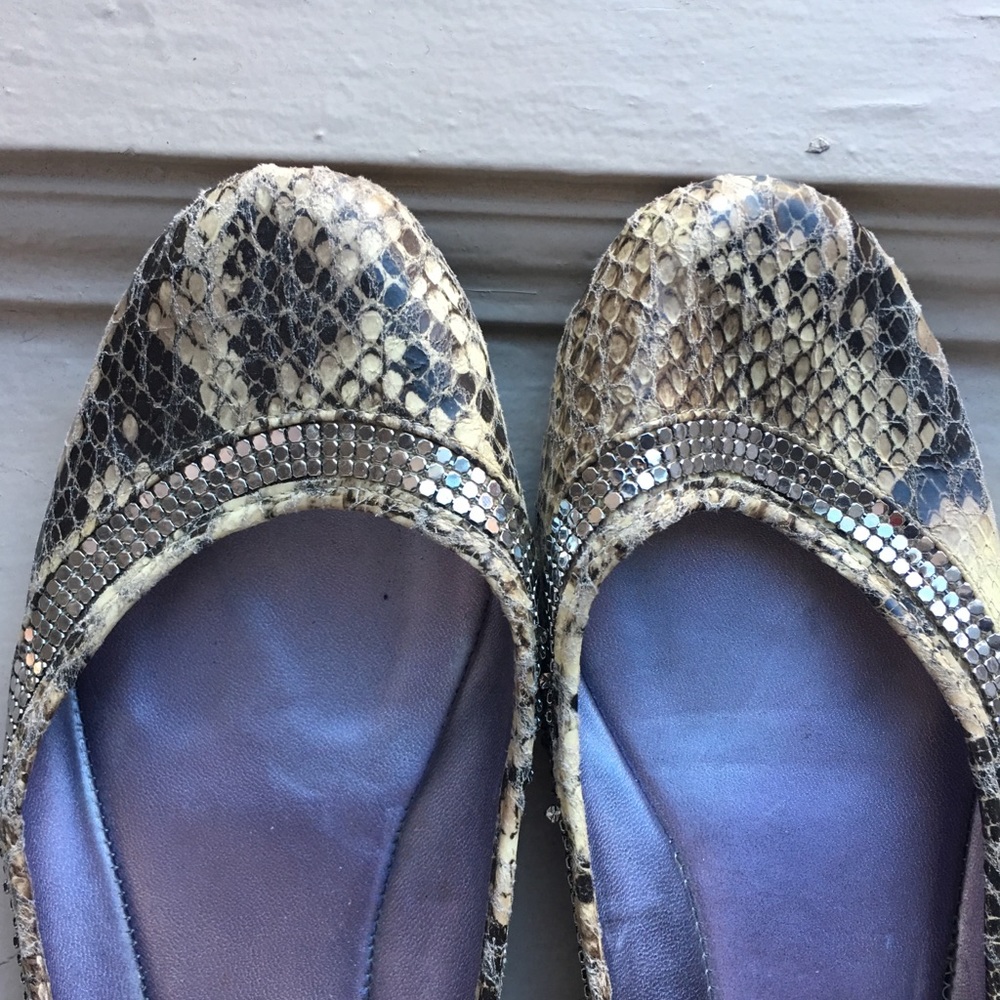 Snakeskin and ring-of-bling Guess flats.