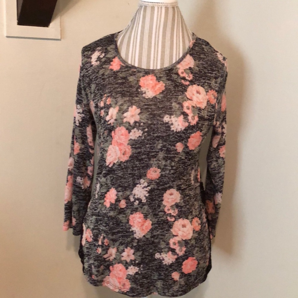 Gently used floral blouse with lace detail at hips