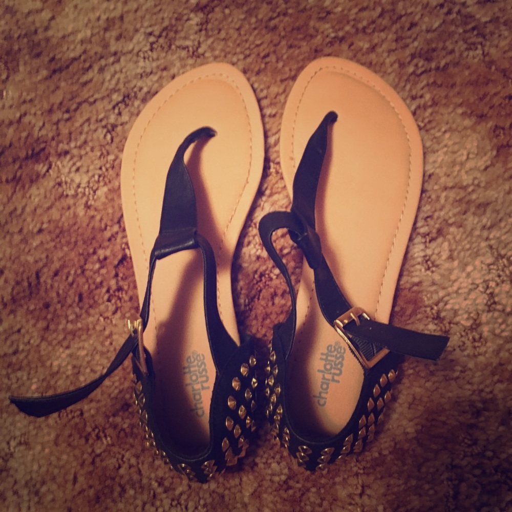 Black sandals with gold hardware.
