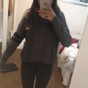 Grey sweater with black stripes on arms