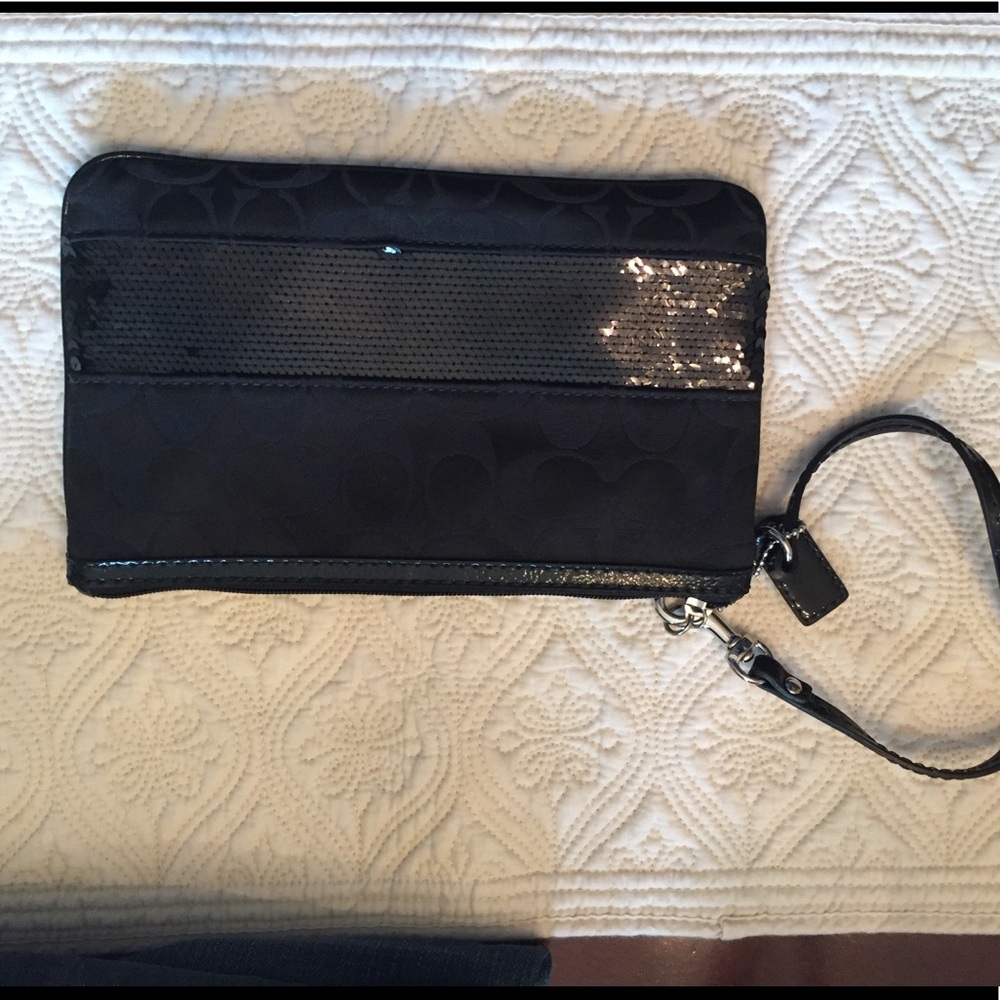 Black COACH wristlet with sequence stripe