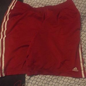 Red Adidas athletic shorts.