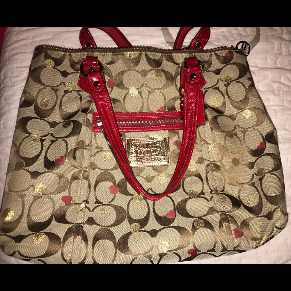 Red, brown, and beige monogrammed coach tote bag