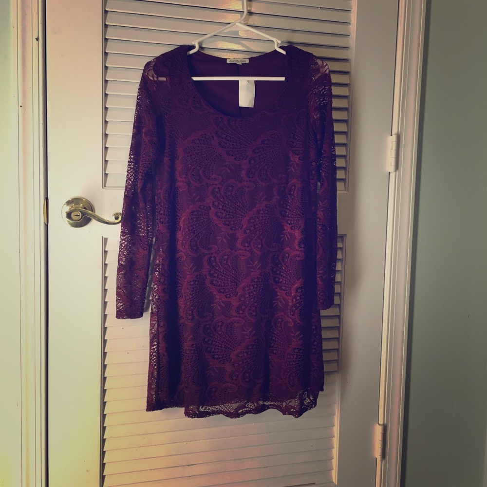 A long-sleeved maroon-colored lace tunic.