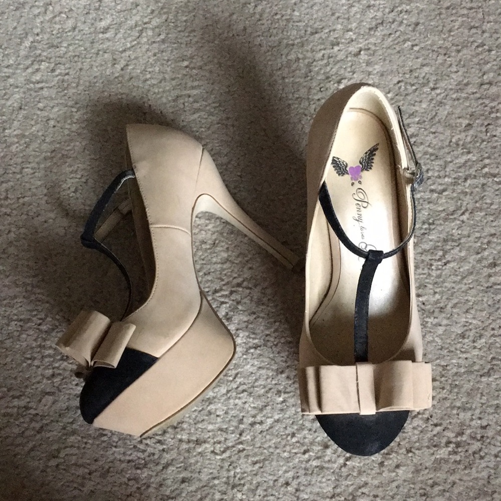 Beige and black heels with bow