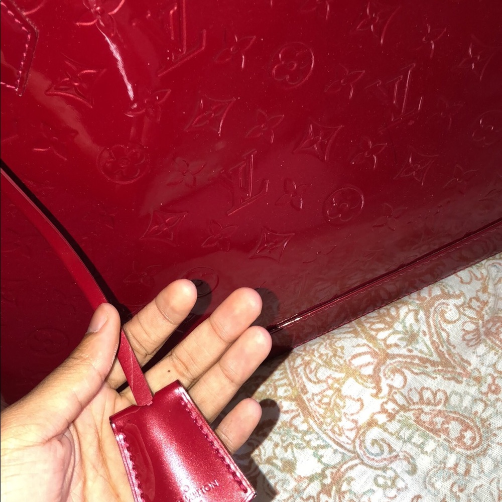 red louis vuitton alma purse.