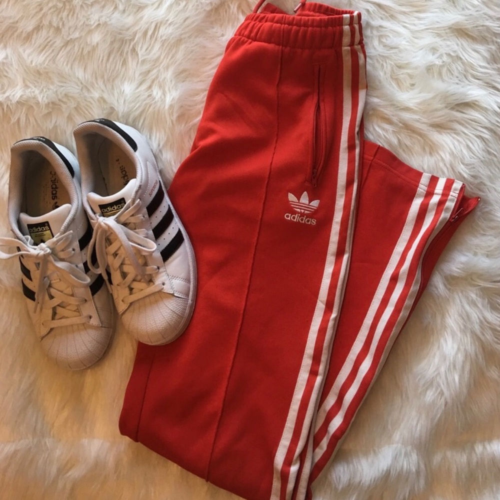 Red and white adidas track pants