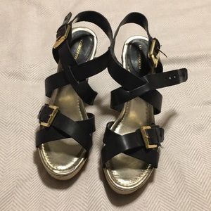 wedges with black straps and gold buckles