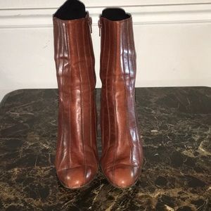 Brown leather stitched heeled boots.