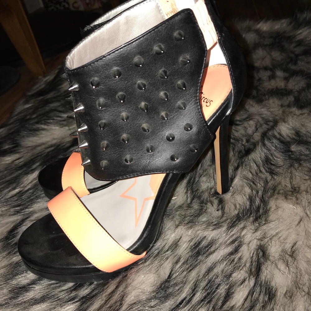 heels with a thick strap covered in metal spikes