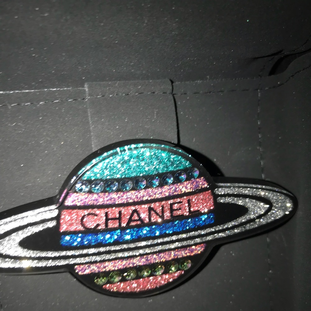 Chanel Saturn resin pin.