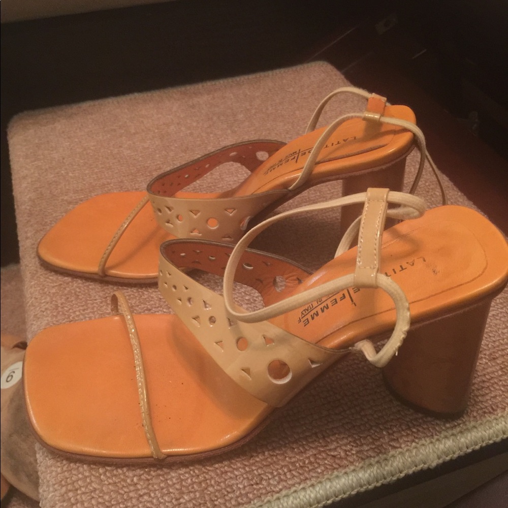 Cream colored strapy sandals.