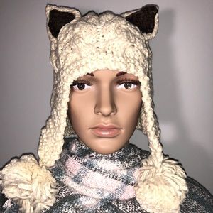 Beige hat with ears and pompons