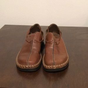 Brown Clark’s slip on shoes.