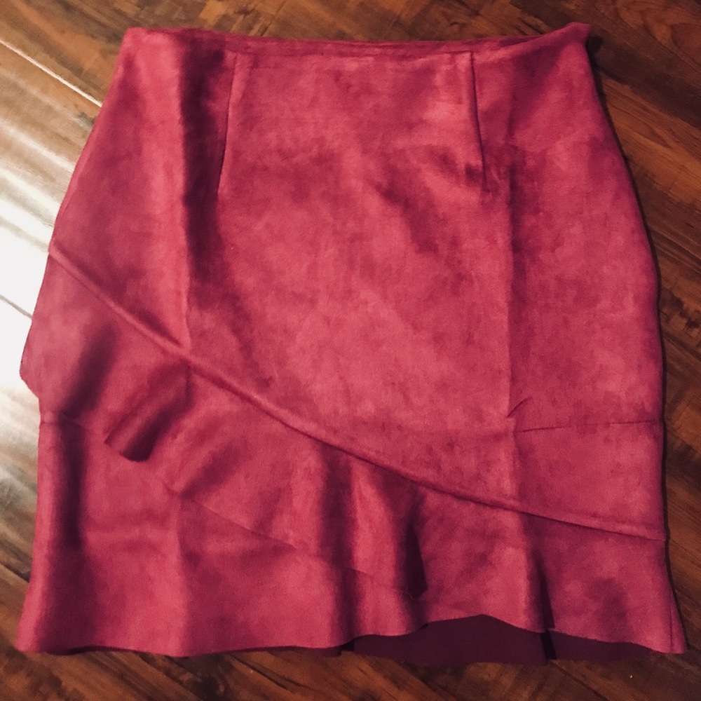 Dark pink suede mini skirt with ruffle trim.