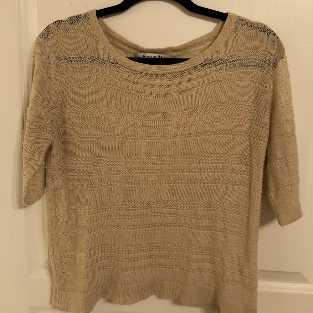 Tan colored rolled-up short sleeve sweater