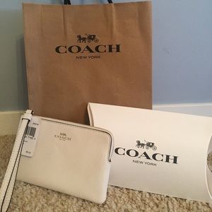 white Coach Wristlet
