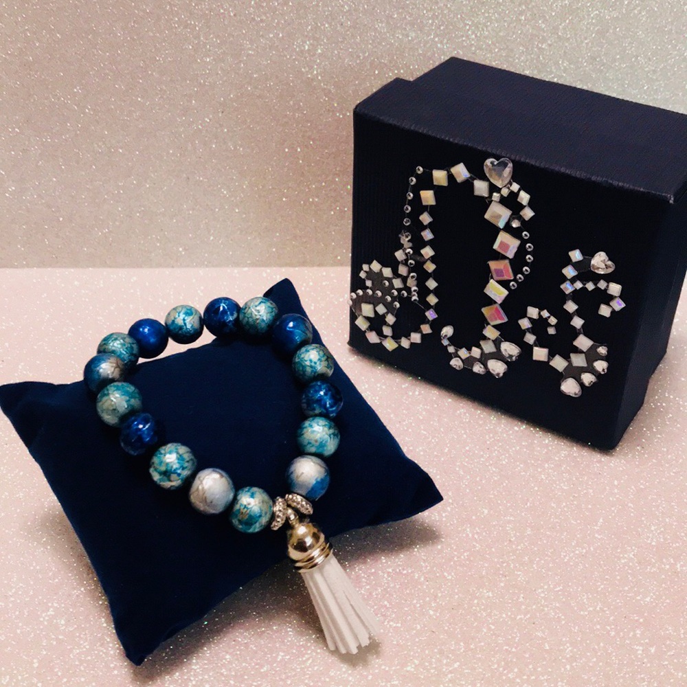 Teen blue and silver bracelet with white tassel