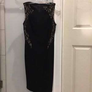 Black sheath dress with lace detail.