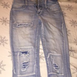 Distressed light blue jeans