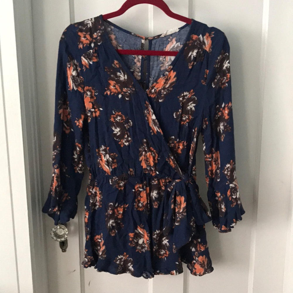 Romper. Button down on back. Ties in the front.