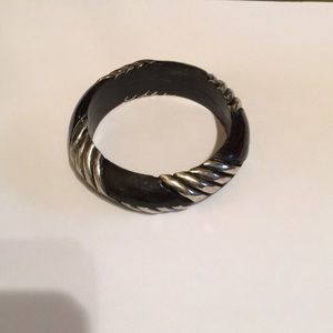 Chunky black and silver bangle bracelet.