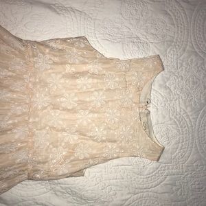 Cream dress with floral design.